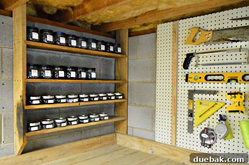 Maximize Tool Storage with a Pegboard 17 Mason jars neatly arranged on shelf above workbench