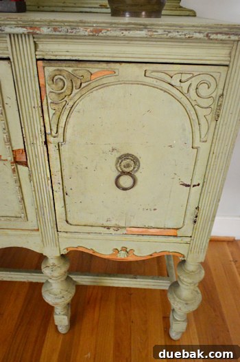 Perfectly Blending New and Existing Paint 3 Close-up of the buffet cabinet showing areas of damage and wear on the wood
