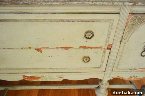 Perfectly Blending New and Existing Paint 8 Before shot of a specific damaged section of the vintage buffet