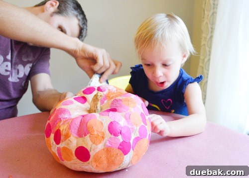 Three Playful Pumpkin Crafts for Little Ones 7 Close-up of tissue paper dots slightly crinkling on the pumpkin surface