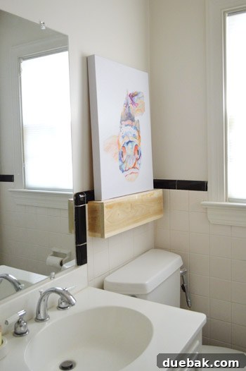 Shelf Your Tile Troubles: A DIY Cover-Up 8 Floating shelf installed over damaged tile, featuring a fish print.
