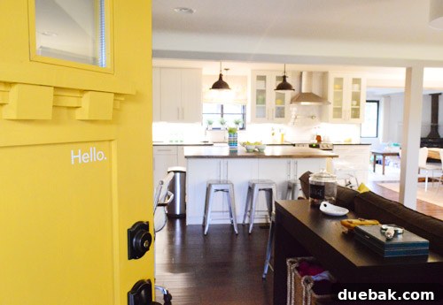Front exterior of a charming yellow door house in Cincinnati, hinting at a personalized interior