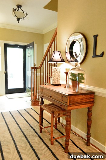 Characterful Comforts: A Home's Warm Embrace 11 Stylish Entryway with Striped Rug and Black Accents