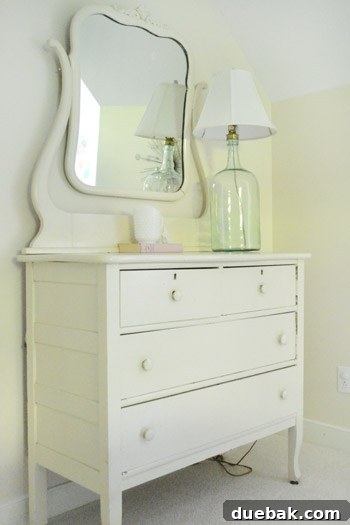 Characterful Comforts: A Home's Warm Embrace 22 Guest Room with Vintage Dresser and Lamp