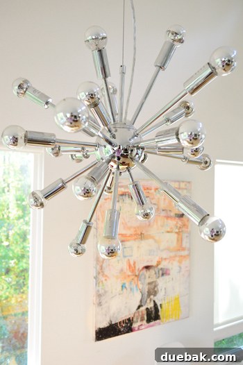 Roommates By Blood 6 Sputnik chandelier illuminating a modern dining space