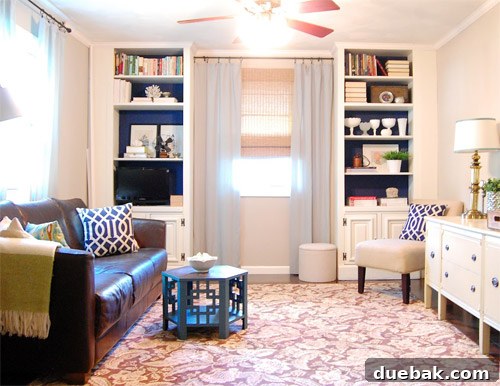 The newly installed built-ins with crown molding and doors, against a navy blue wall