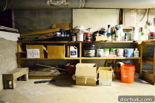 Before image of disorganized paint shelf