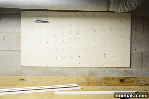 Pegboard with tools before the frame and paint