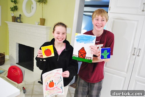 Niece and nephew with their 'practice' art sheets and final artworks for the book.