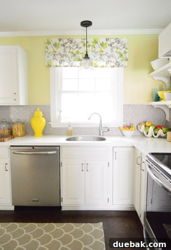 Faux roman shade beautifully installed over the kitchen window, concealing hardware