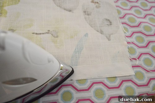 Close-up of fabric being hemmed with no-sew iron-on tape