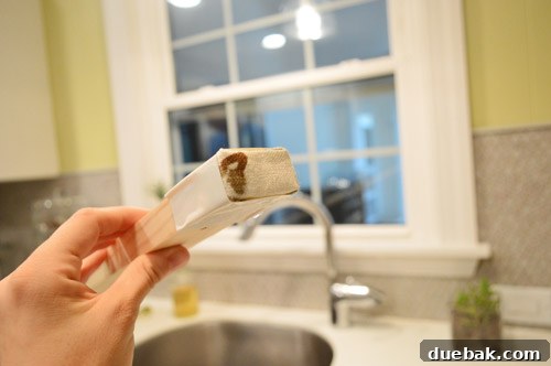 Ends of the wood header wrapped in fabric scraps and secured with white duct tape