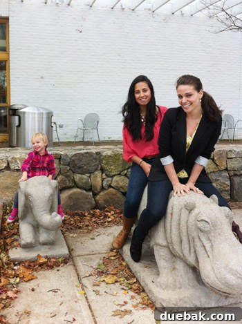 Roo, Sherry, and Clara posing on animal statues outside Wilton Library