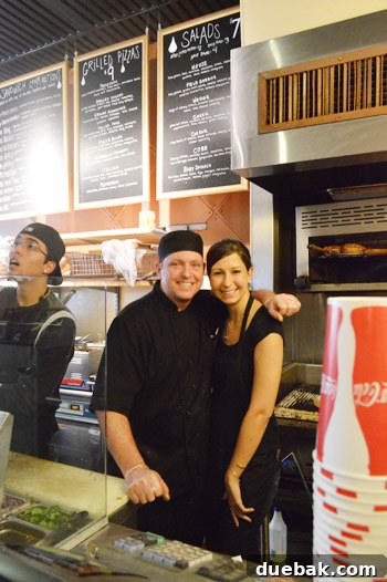 Bill and Kristin, owners of Melt Sandwich Shop, smiling during John and Sherry's visit