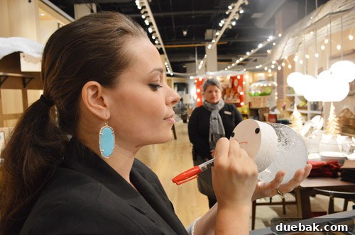 Sherry signing a beautiful snow globe at the West Elm Boston book signing
