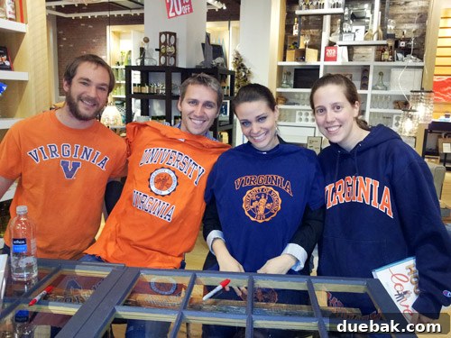 John and Sherry posing with fans wearing UVA shirts at the West Elm Boston book signing
