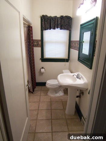 Outdated bathroom before renovation with generic fixtures and dull coloring