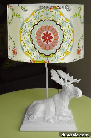 A moose lamp transformed with white paint and a colorful shade.