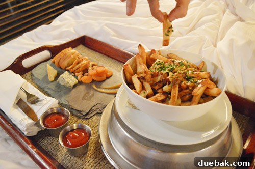 New York, Richmond, Chicago, Toronto: City Tapestry 32 A plate of poutine from hotel room service