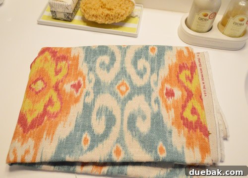Elevate Your Windows with Frosting 2 Bold Ikat patterned fabric in blue, orange, and red tones, called Ubud by Iman Home/Waverly