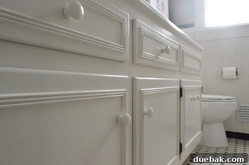 Elevate Your Windows with Frosting 3 Old country-style white painted wooden knobs on a bathroom vanity