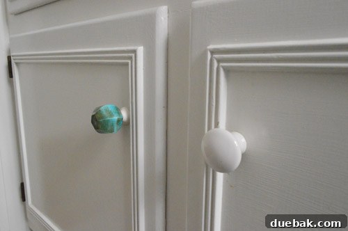 Elevate Your Windows with Frosting 5 New irregular green-jade-like knobs installed on a white bathroom vanity