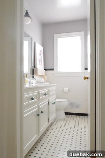 Elevate Your Windows with Frosting 7 Full view of the white bathroom vanity with new knobs and a glimpse of the floor tile