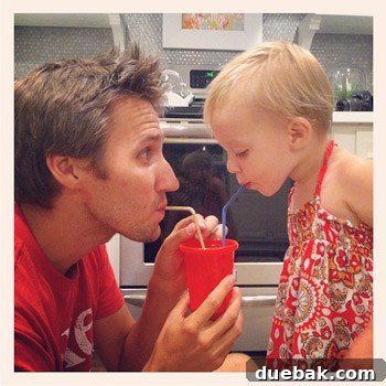 John sharing a loving moment with his family