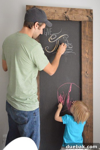 Crafting Your Thanksgiving Gratitude Board 2 John and daughter both writing on large leaning DIY chalkboard with wood frame