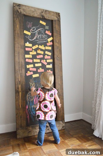 Crafting Your Thanksgiving Gratitude Board 12 Toddler girl drawing on DIY leaning chalkboard with Thanksgiving gratitude notes
