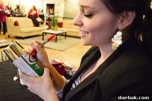 Sherry Petersik signing a spray paint can for a fan at a book event.
