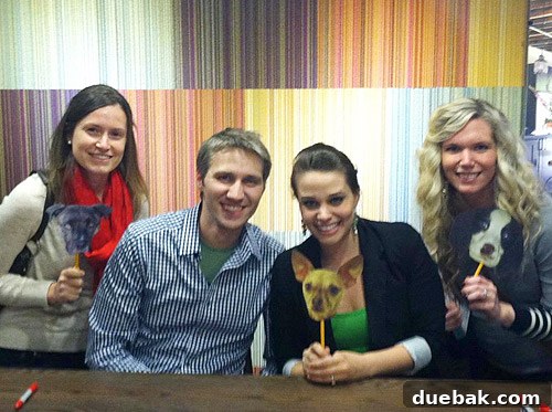 Paper cutout of Burger, the authors' dog, playfully 'photobombing' a book tour photo.
