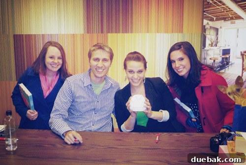 Authors posing with Caroline and Katie, celebrating Katie's wedding with a surprise orchestrated by her husband Bob.