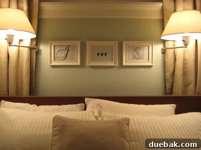 Elegant framed initial 'J' and 'S' wall art above a bed