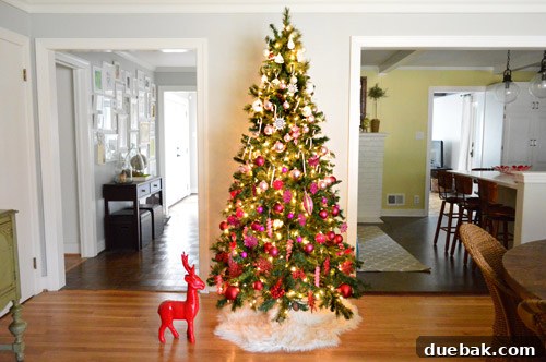 Far View Of Gradient Christmas Tree Sitting Between Hallway And Kitchen
