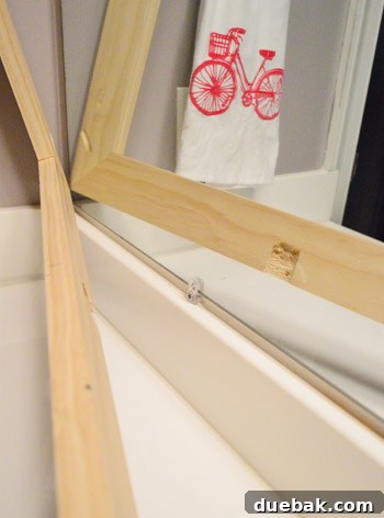 Testing the fit of the mirror frame against the mirror and clips