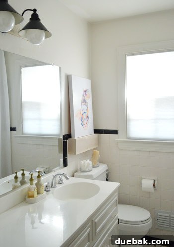 Before shot of the unframed builder-grade mirror in the bathroom