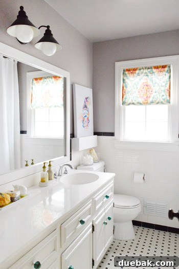 Full bathroom after the budget-friendly update, including the mirror frame