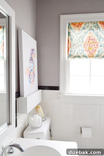 Close-up of the vanity area in the updated bathroom, showing new knobs and framed mirror