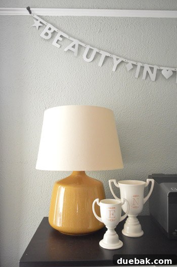 House Transformation: Finally Home 10 Close-up of monogrammed trophies and yellow lamp in Nicole's office