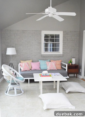 Full view of the transformed sunroom wall after painting, demonstrating the cohesive gray color scheme.