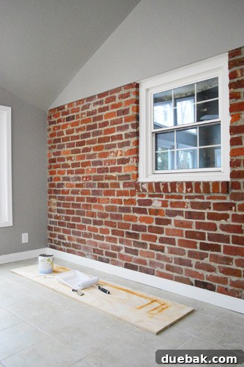 Close-up of the unpainted interior brick wall in the sunroom, highlighting its 'weird' shape.