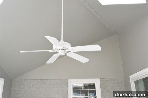 Sunroom interior after painting all walls and ceiling in a cohesive gray, downplaying architectural quirks.