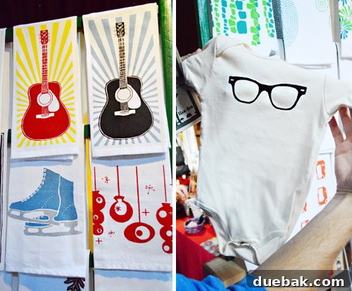 Tiny Peepers screenprinted tea towels and a charming baby onesie, showcasing unique fabric designs