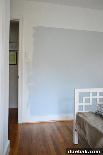 Close-up of a wall section in the playroom with stenciled patterns and different paint colors