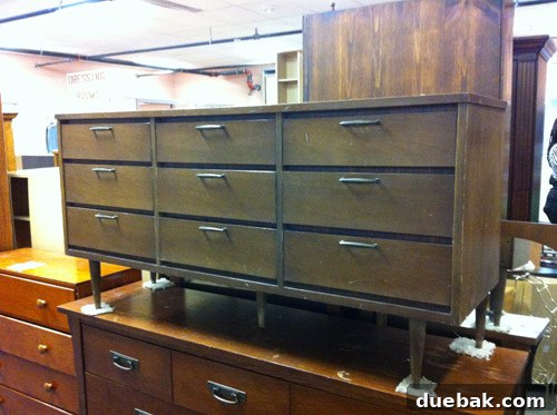 Thrifted Dresser Reimagined as a Media Console 3 Full view of the vintage wooden dresser, Mia, in the thrift store, showcasing its six drawers and overall design.