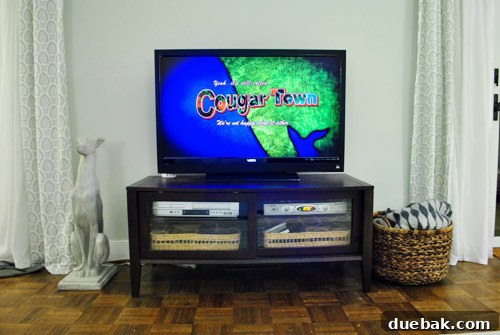 Thrifted Dresser Reimagined as a Media Console 4 Our existing small media console, looking dwarfed by a large television mounted above it, highlighting the need for an upgrade.