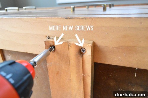 Thrifted Dresser Reimagined as a Media Console 8 A close-up of a furniture joint, showing wood glue being applied with a paperclip to reinforce the connection and stop the wobble.