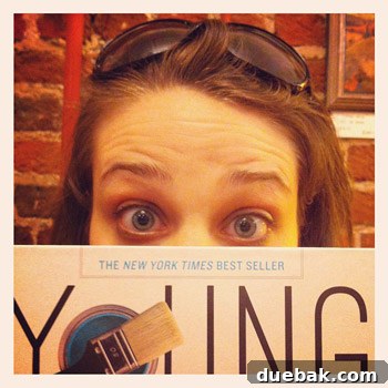 Smiling authors holding their book, celebrating a milestone.