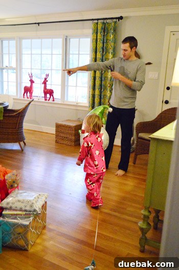 Clara happily playing with her new handmade play fridge on Christmas morning